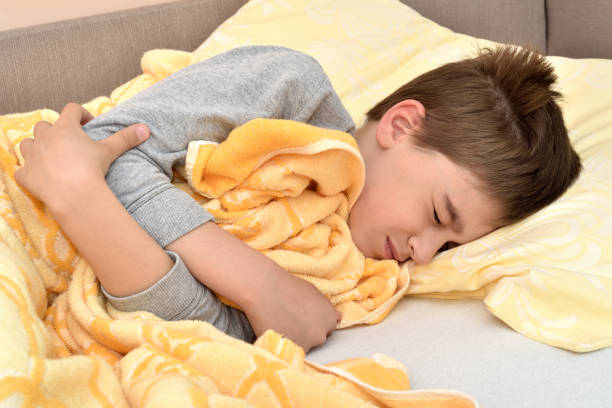 istock Ill young boy lying in bed 1141442977