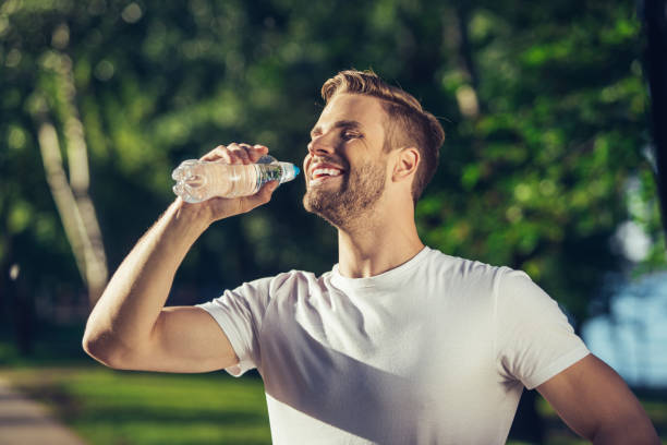 istock Positive bristled man is enjoying beverage in park 1141443544