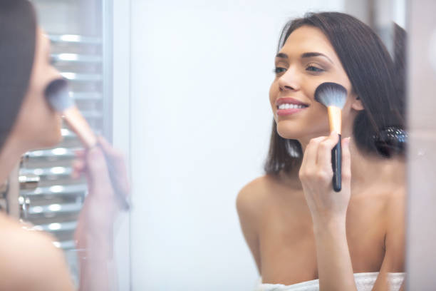 istock Attractive woman holding a makeup brush 1141443885