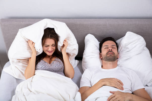 istock Woman Covering Her Ears While Man Snoring In Bed 1141448032
