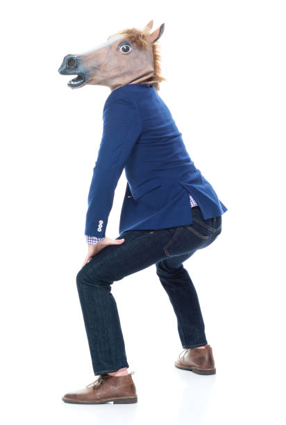 istock Businessman with horse mask is dancing 1141449488