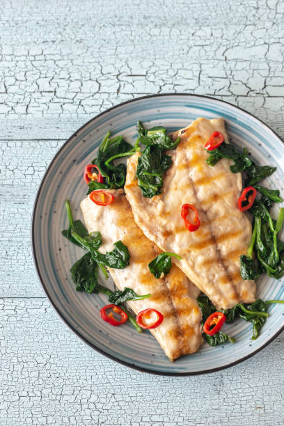 Grilled sea bream fish fillet with spinach