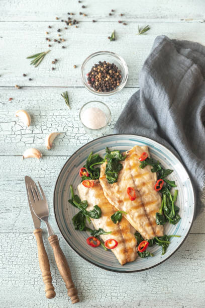 istock Grilled sea bream fish fillet with spinach 1141451478
