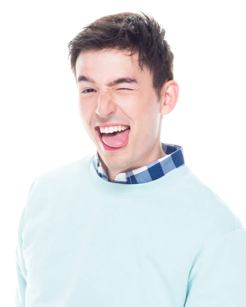Attractive man is super happy Attractive man wearing sweater and jeans young man wink stock pictures, royalty-free photos & images