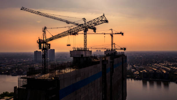 istock Construction site silhouette background, Hoisting cranes and new multi-storey buildings, Aerial view Industrial background. 1141451970