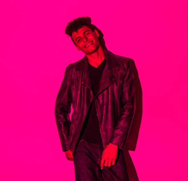 istock Handsome man in colorful lighting 1141452178