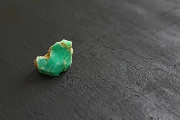 Chrysoprase is a natural stone mineral, a collection of natural stones on a black background. Green stones. Copy space for your text.