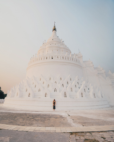 Young Caucasian women exploring white Hsinbyume Pagoda in Mandalay