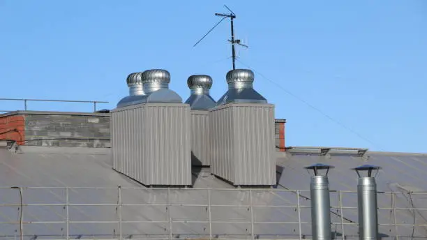 shiny metal air ventilation on the roof rotates to clean the air in the building and regulate the temperature.