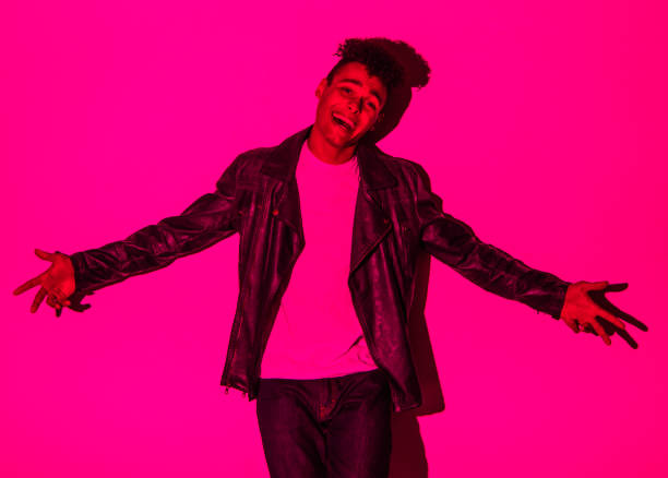 istock Handsome man in colorful lighting 1141453279