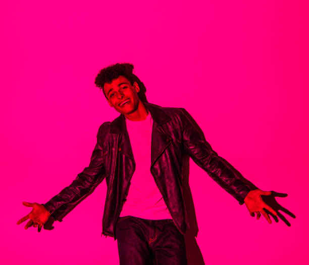 istock Handsome man in colorful lighting 1141453555
