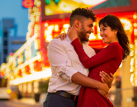 A couple embracing and smiling at each other in Las Vegas's traditional Fremont district.