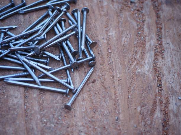 istock close up iron nails on old wooden table in construction site. building construction and industry concept 1141455024