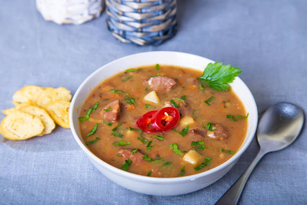 istock Pea soup with meat, smoked sausages and crackers. 1141455028