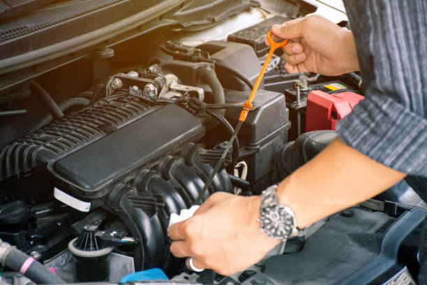 istock Man or auto mechanic worker hands checking the car engine oil and maintenance before traveling for safety. 1141455271