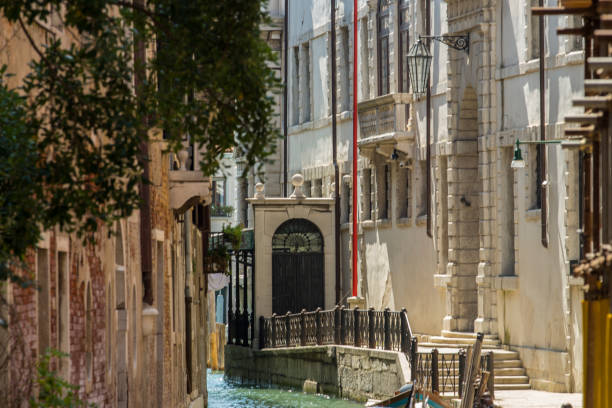 istock Narrow canal and side walk at Venice, Italy. 1141455411