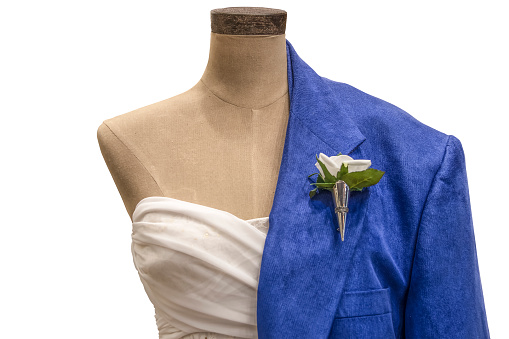 Mannequin with formal dress on one side and suit with buttonhole flower on the other side for spring wedding or prom - closeup and isolated on white
