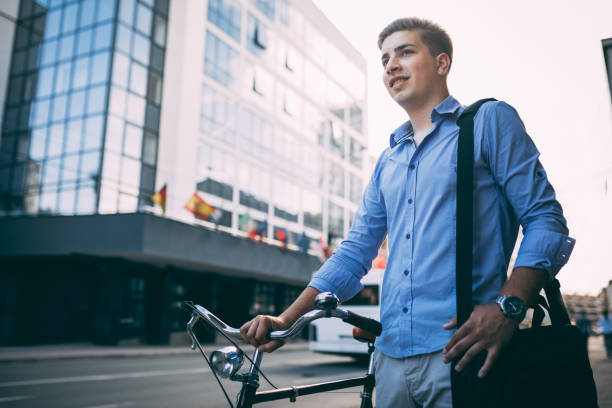 istock Handsome young man in the city with bicycle 1141458212