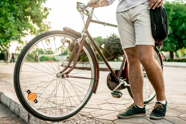 istock Side view of bicycle and guy next to it 1141458357