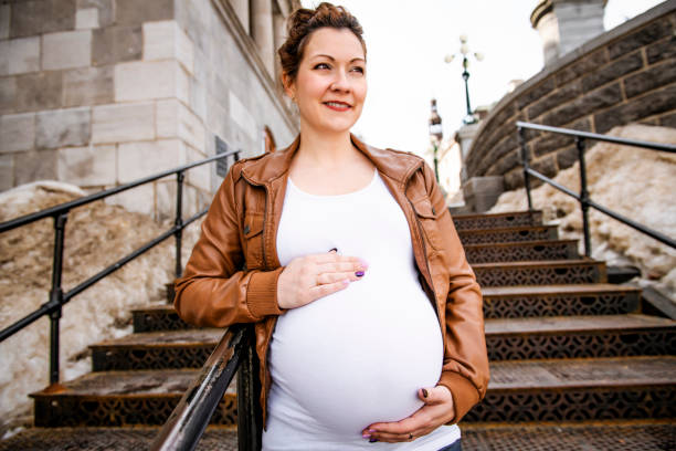istock Pregnant girl outside on a rust stair 1141458907