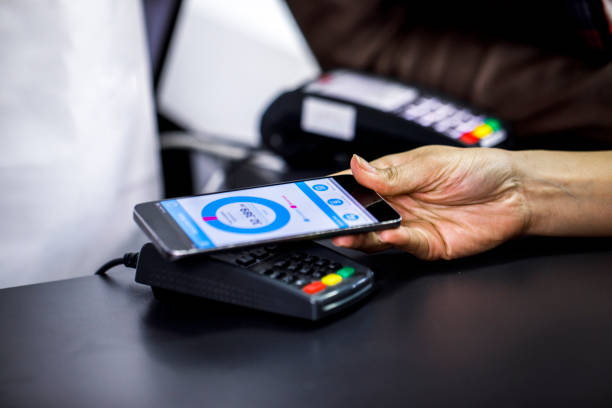 istock Using a mobile phone virtual wallet application to make a contactless purchase in a store 1141459303