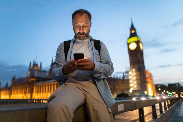 istock Mature man using smart phone in front of Big Ben 1141460535
