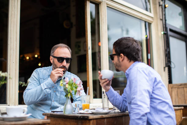 istock Two male friends enjoying coffee time 1141460551