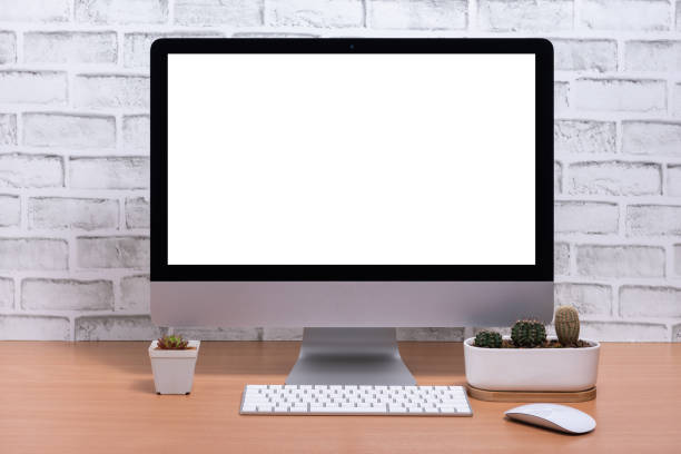 istock Blank screen of All in one Computer with cactus pots on wooden table, White brick wall background 1141462230