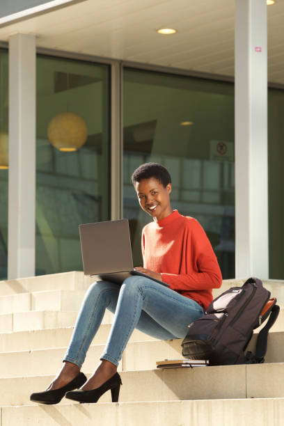 istock happy female student working with laptop on college campus 1141462737