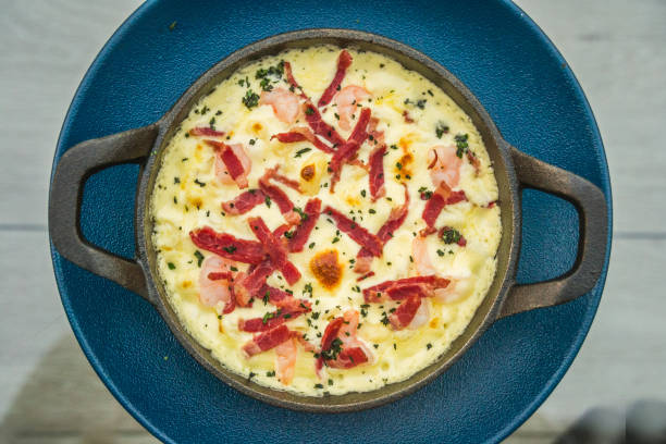 istock Mac and cheese with prawns, beef bacon and baby green flower 1141462967