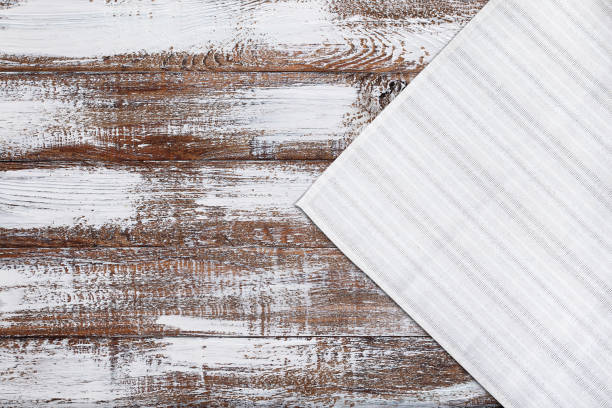 istock Old vintage wooden table with white tablecloth. Top view mockup. 1141463993