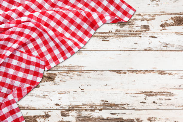 istock Vintage white wooden table with red checkered tablecloth. Top view mockup. 1141463994
