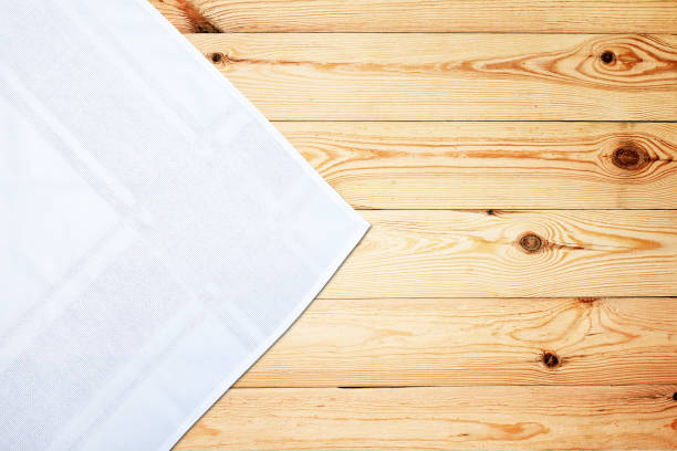 istock Old vintage wooden table with white tablecloth. Top view mockup. 1141463998