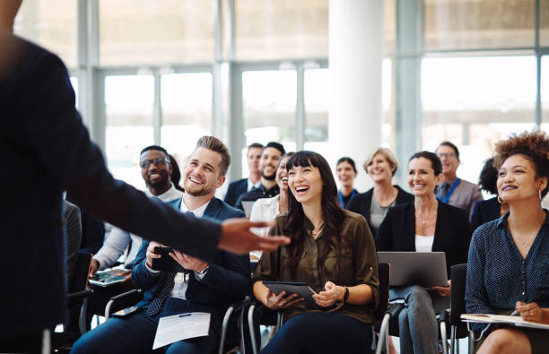 Every presenter's dream, an audience full of go getters Shot of a group of businesspeople attending a conference getters stock pictures, royalty-free photos & images