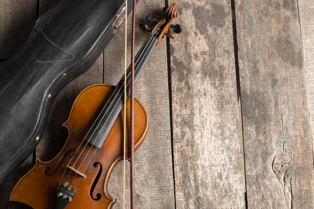 istock Violin on a wooden textured table 1141464442