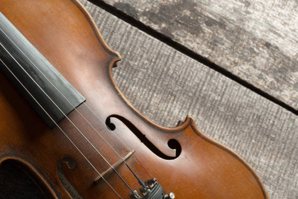 istock Violin on a wooden textured table 1141464514