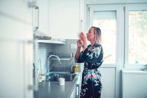 istock Housewife Searching For Coffee In Cupboard 1141466018