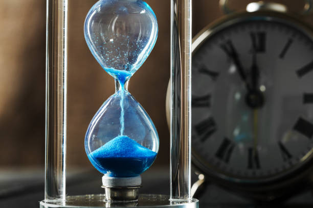 istock Time is passing. Blue hourglass close up 1141466273