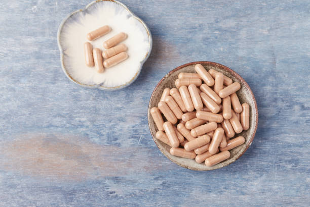 istock Cat's Claw (Uncaria tomentosa)  Extract Capsules. A Dietary Supplement. Immune System Support. Rustic wooden background. Directly Above . Copy space. 1141466467