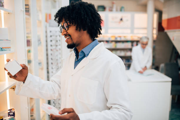 istock Pharmacist looking at medicine and smiling 1141468145