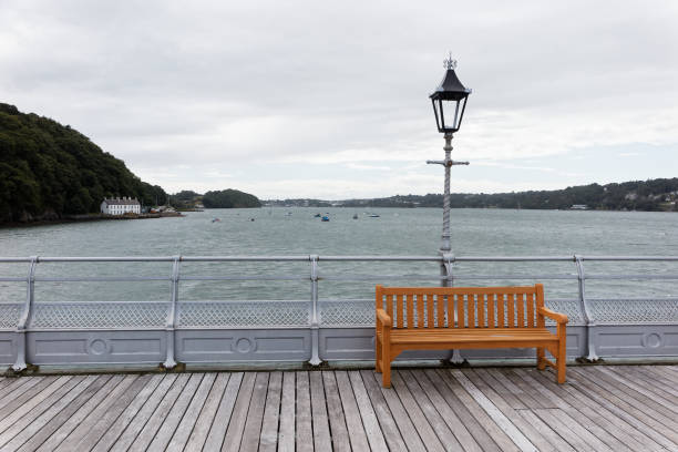 istock Lonely bench on the pier under the lantern. 1141468385