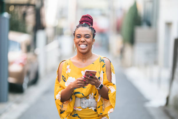 istock Happy woman using smart phone in city 1141468568
