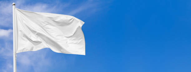 istock White flag waving in the wind on flagpole against the sky 1141469108