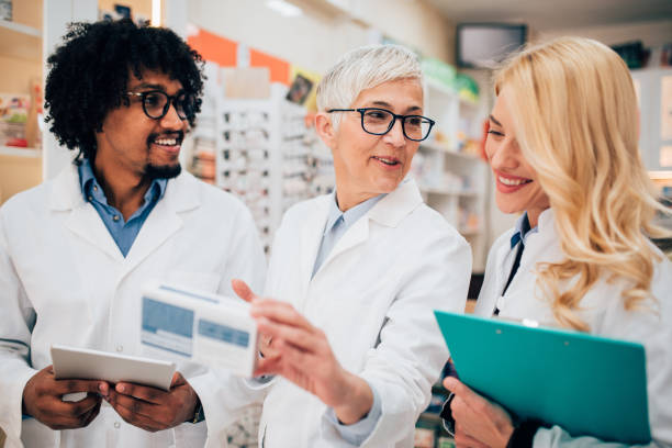 istock Pharmacist talking about medicine with coworkers 1141471673
