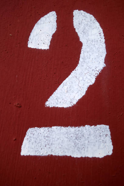 istock Red color number 2 in stencil on metal wall. 1141471877