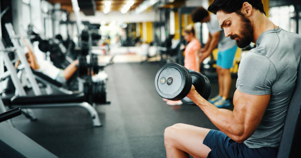 istock Determined handsome and young male working out in gym 1141473977