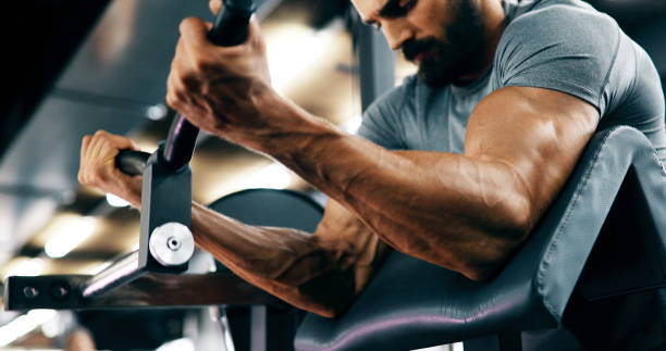 istock Determined handsome and young male working out in gym 1141474000