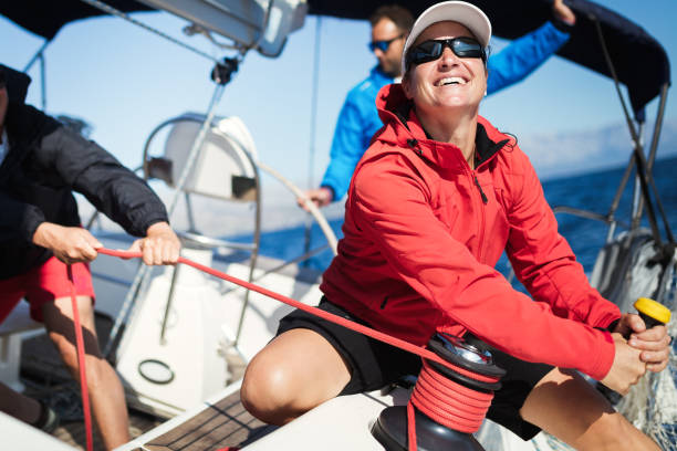 Attractive strong woman sailing with her boat