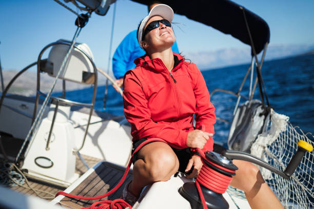 istock Attractive strong woman sailing with her boat 1141474454
