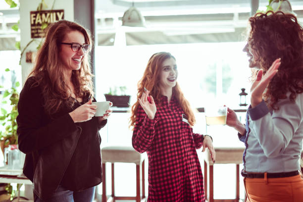 istock Gossiping Female Colleagues Drinking Coffee 1141474530